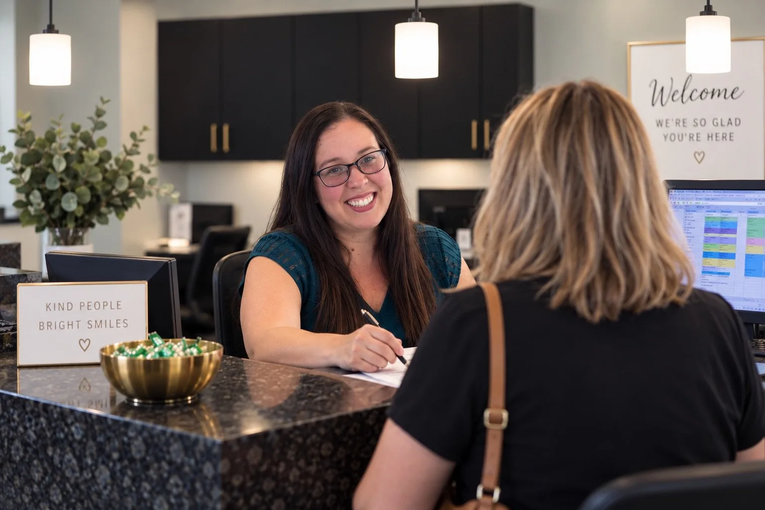 A friendly Johnson Ranch Dental team member checking in a patient